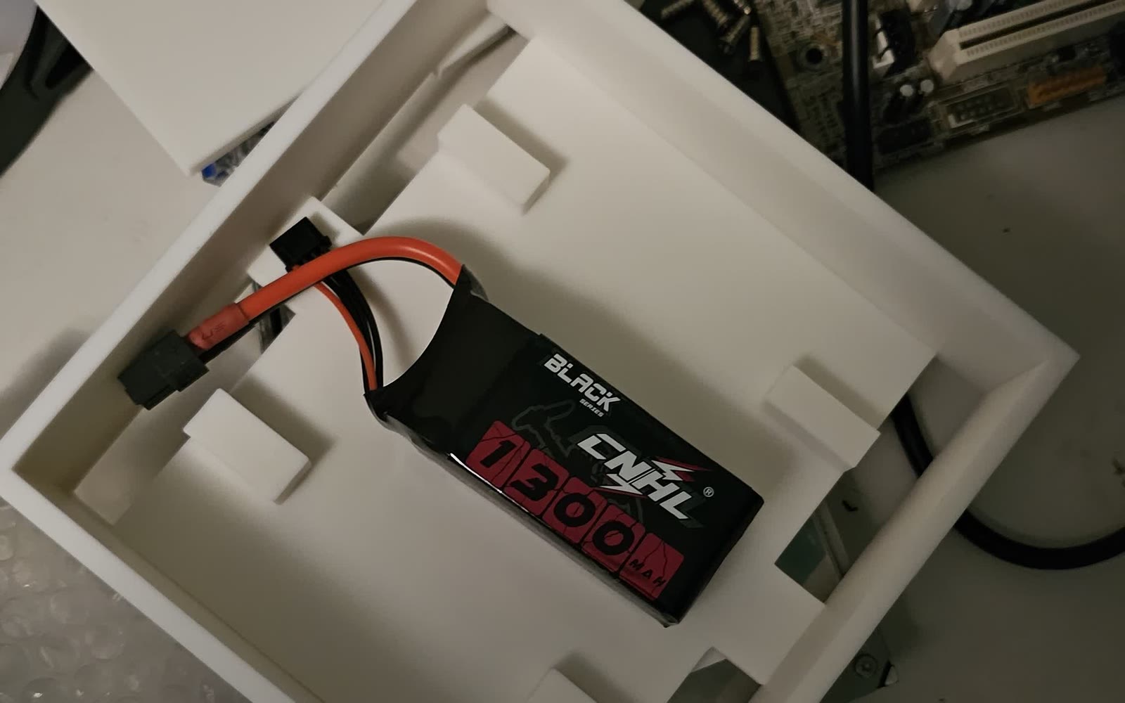 A LiPo battery seated in a 3D-printed foam-lined battery mount