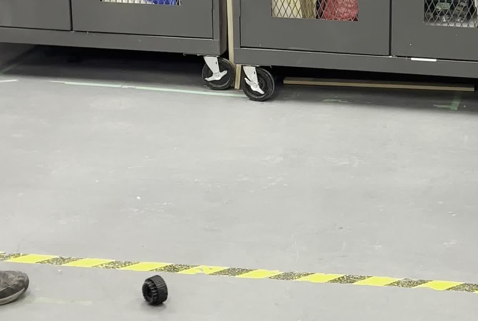 A printed wheel on the floor after a drop test at a shared makerspace