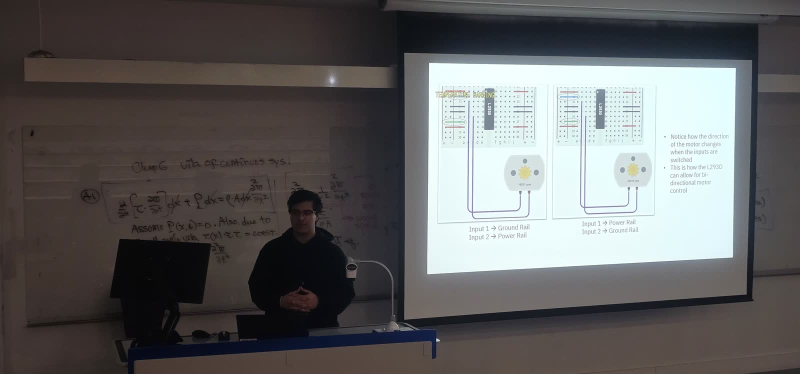 The presenter talking to the room in front of the motor driver wiring slide